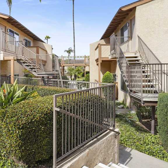 a sunny day at a residential complex with a clear blue sky.