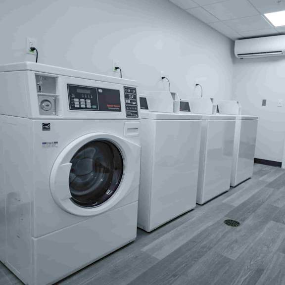 a row of washing machines in a laundromat.
