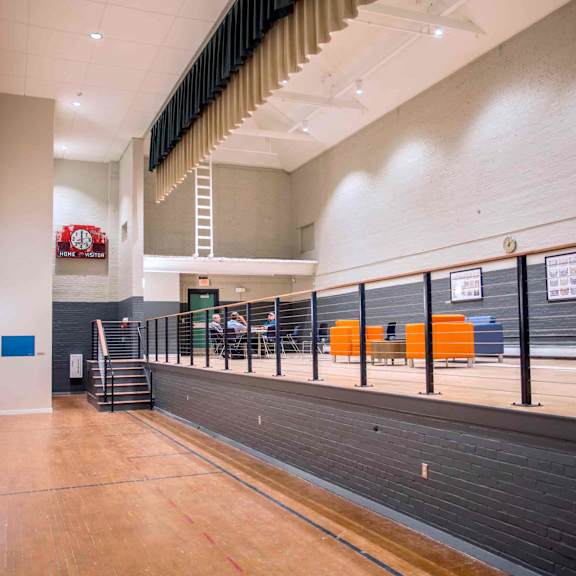 a long hallway with a basketball court at the end.