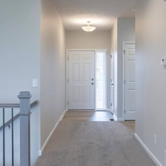 a hallway with a carpeted floor and a light on the ceiling.