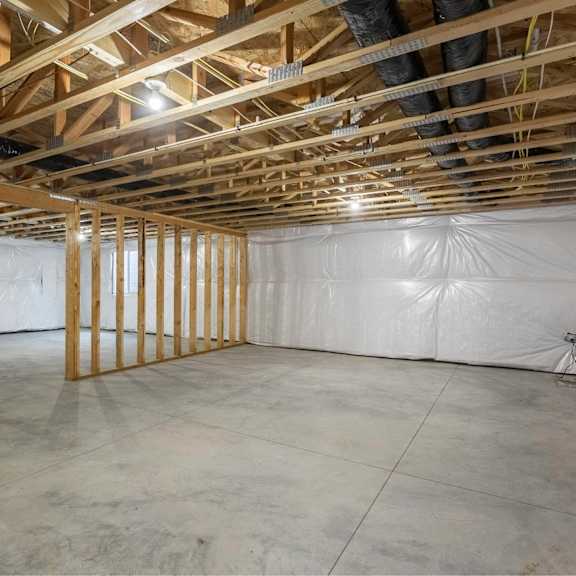 a room under construction with wooden beams and insulation.