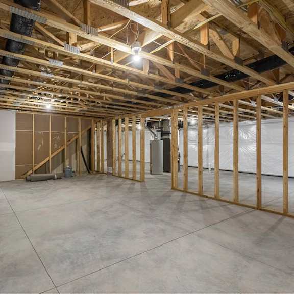 a room under construction with wooden beams and unfinished walls.