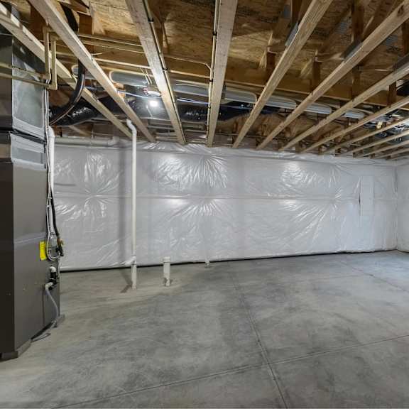 a room with a white ceiling and walls, covered in plastic, with a door on the left.
