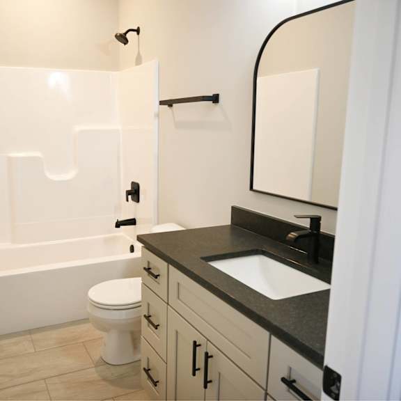 a white toilet sits in a bathroom next to a sink.