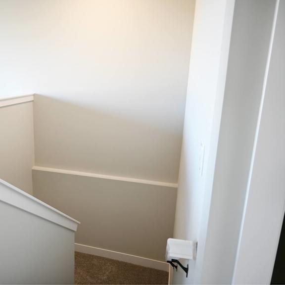 a white staircase with a carpeted floor.