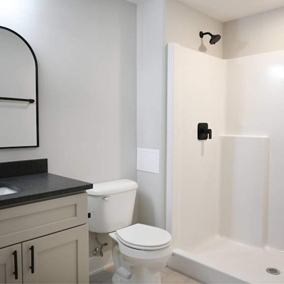 a white toilet sits next to a sink in a bathroom.