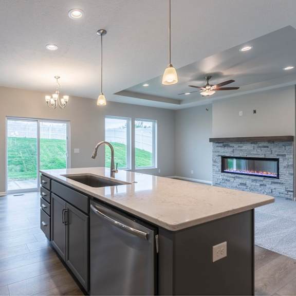 a modern kitchen with a large island and a fireplace.