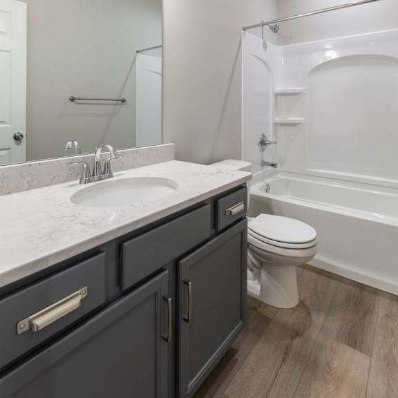 a bathroom with a sink, toilet, and bathtub.