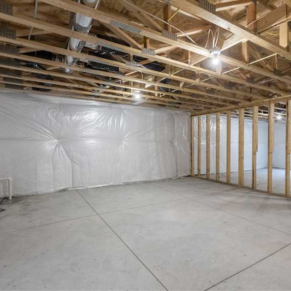 a room under construction with wooden beams and insulation on the walls.