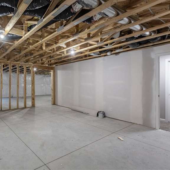 a room under construction with wooden beams and no walls.