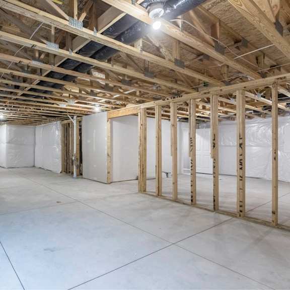 a sparsely furnished room with wooden beams on the ceiling.
