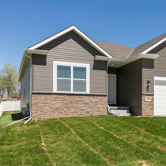 a house with a garage door and a window.