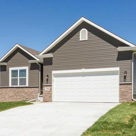 a house with a garage door and a driveway.