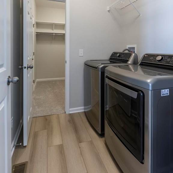 a kitchen with a stainless steel oven and a white door.