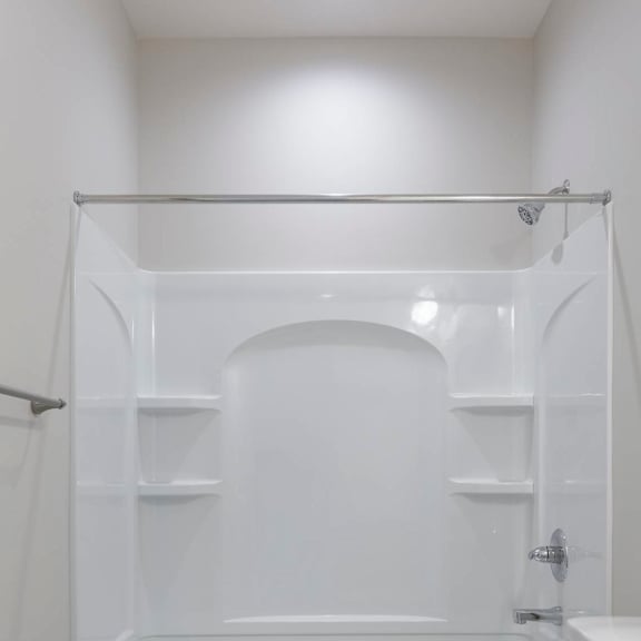 a white bathroom with a toilet, sink, and bathtub.