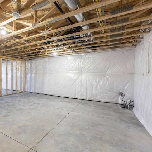 a room under construction with wooden beams and insulation on the walls.