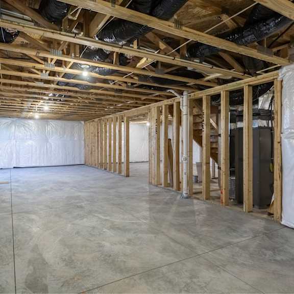 a room under construction with wooden beams and insulation on the walls.