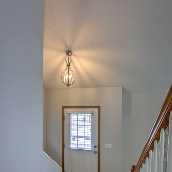 a staircase with a light hanging above it.