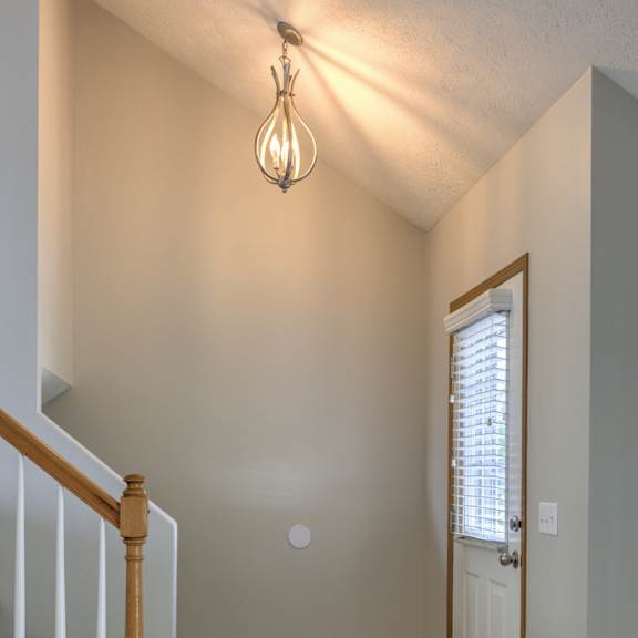 a room with a staircase and a door.