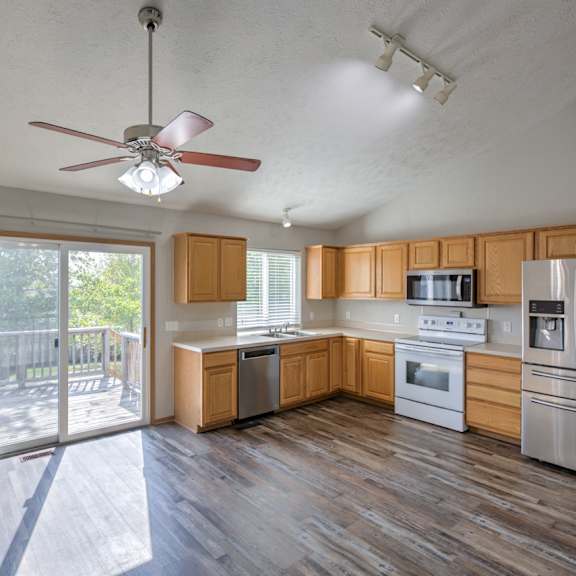 a kitchen with wooden cabinets and stainless steel appliances.
