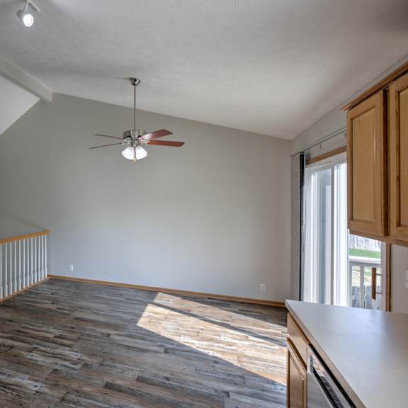 a room with a wooden floor and a ceiling fan.