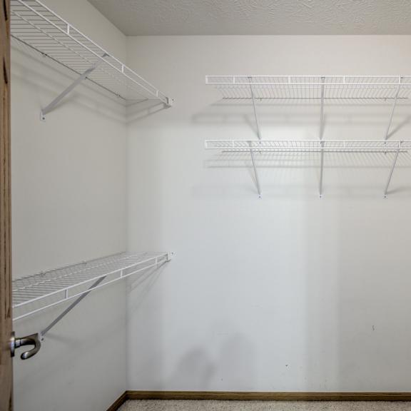 empty white shelves in a room.