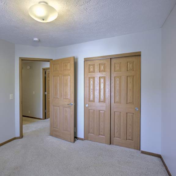 a room with two doors and a carpeted floor.