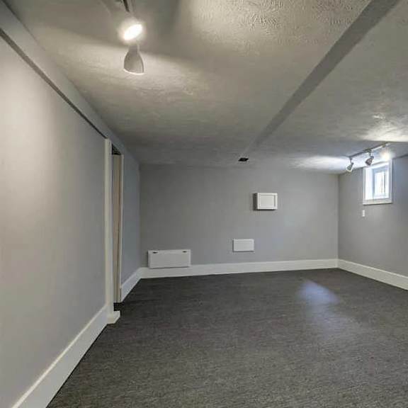 a room with grey carpet and white walls.