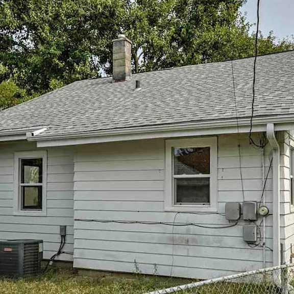 back of a house that is painted white.