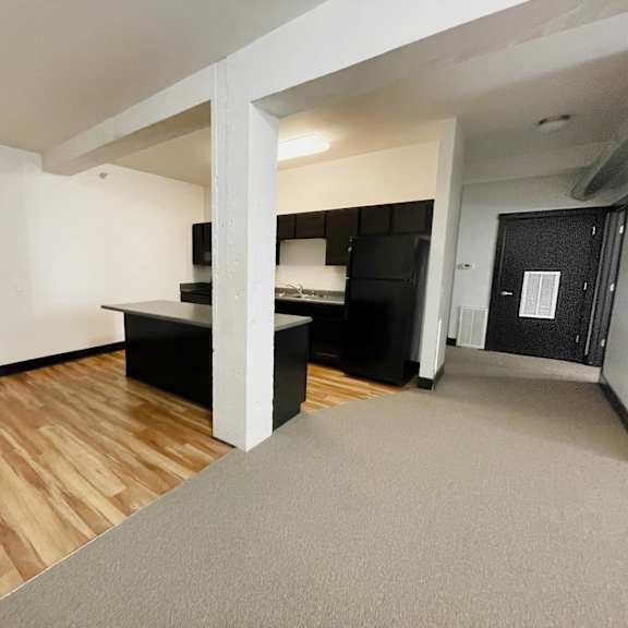 a room with a grey carpet and wooden floors.