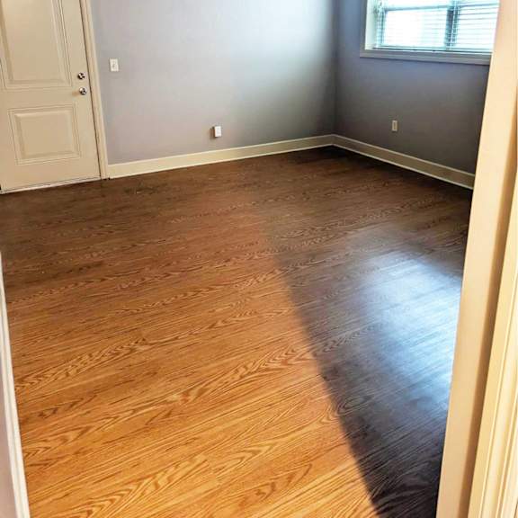 a room with wooden flooring and a door.