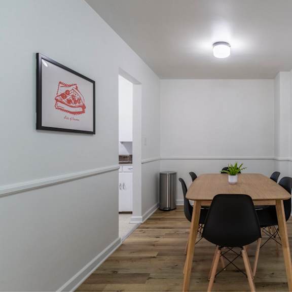 a dining room with a table and chairs.