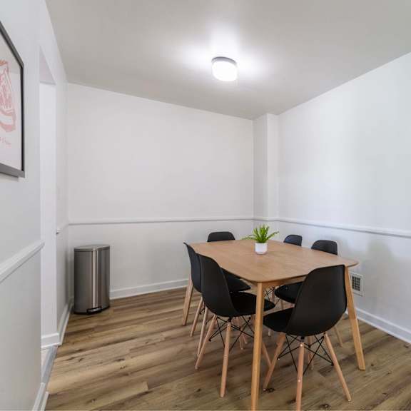 a dining room with a table and chairs.
