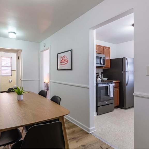 a dining room with a table and chairs.