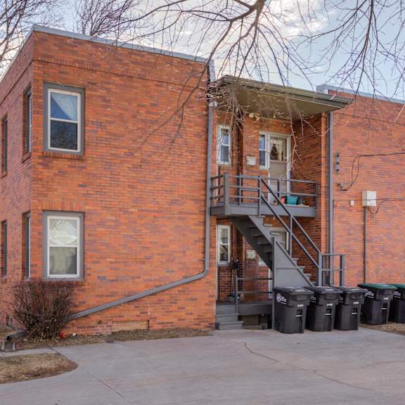 a red brick building with a car parked in front.