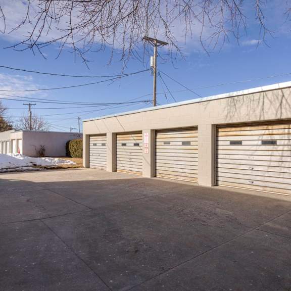 a building with a grey roof and grey garage doors.