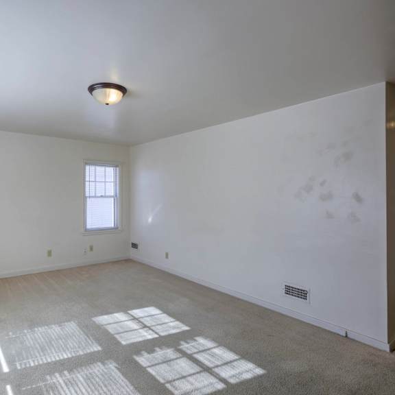 a room with a window and a ceiling light.