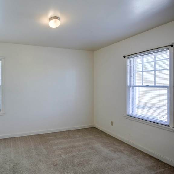 a room with a window and a car parked outside.