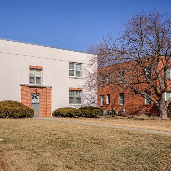 a white building with a red door and windows.