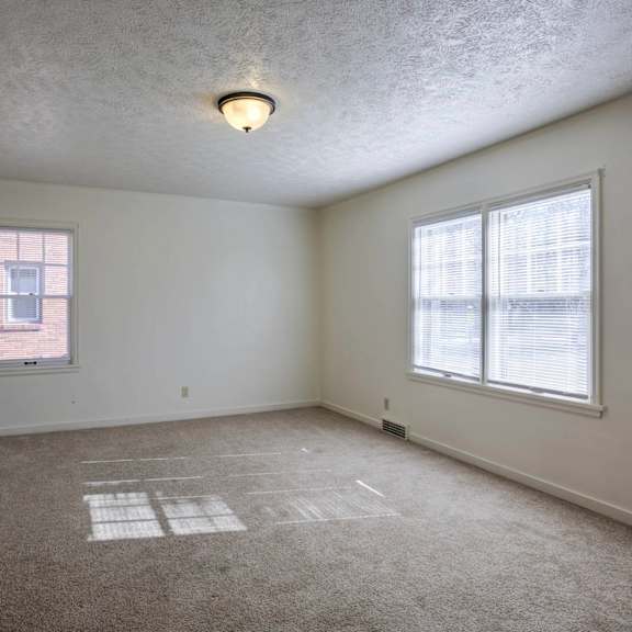 a room with a window and a ceiling light.