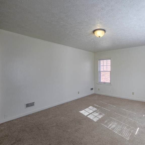 a room with a window and a carpet with lines drawn on it.