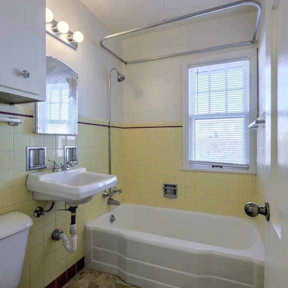 a white toilet sits next to a sink in a bathroom.