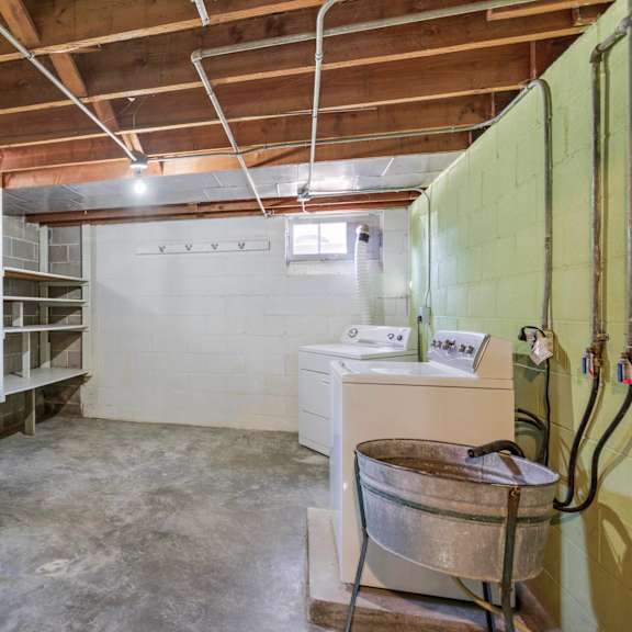 a room with bunk beds and a desk.