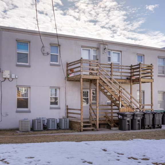 a building with a wooden staircase in front of it.