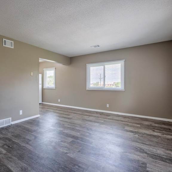 a room with a wooden floor and a window.
