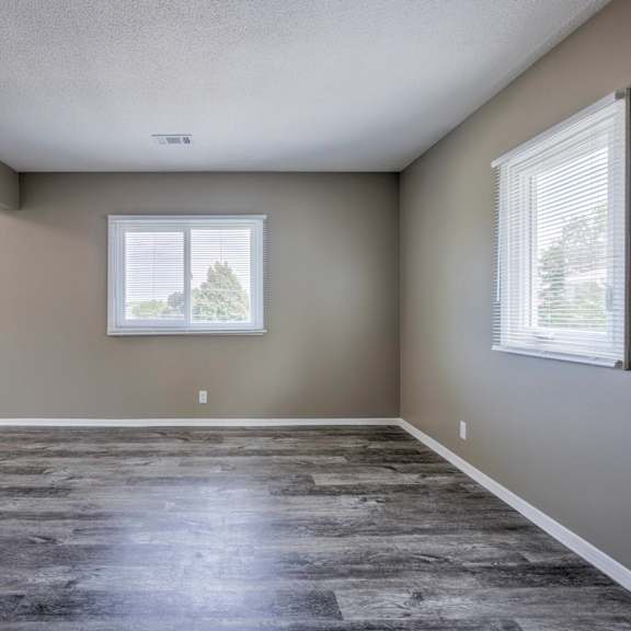 a room with a large window and a slanted ceiling.