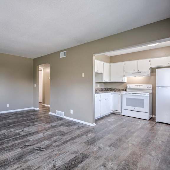 a kitchen area with a refrigerator, microwave, and oven.