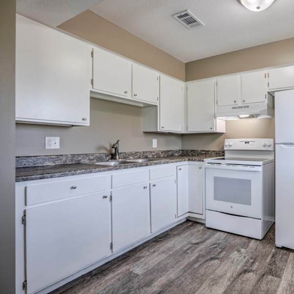 a kitchen with white appliances and cabinets.