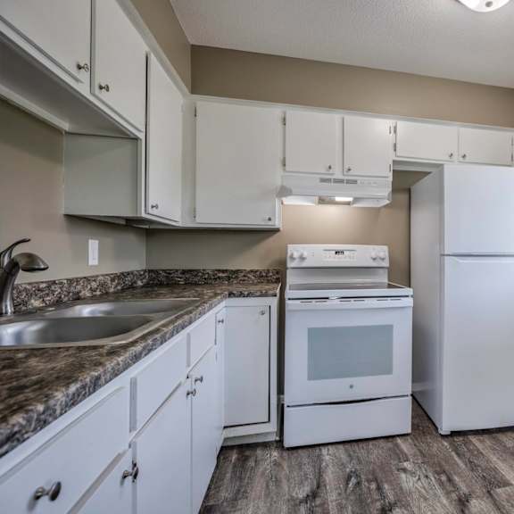 a kitchen with white appliances and cabinets.