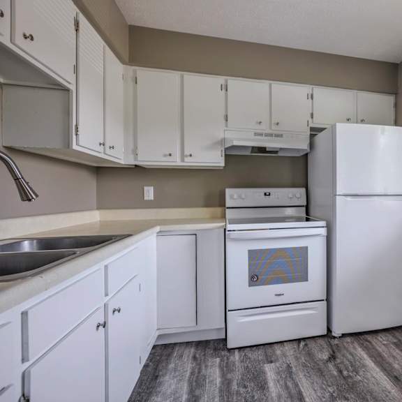 a kitchen with white appliances and cabinets.